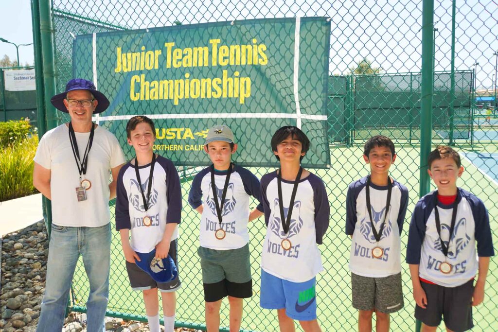 coach with junior team tennis