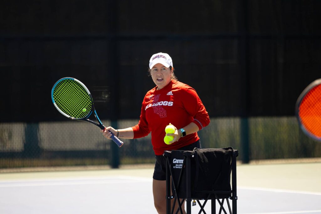 tennis coach with racket